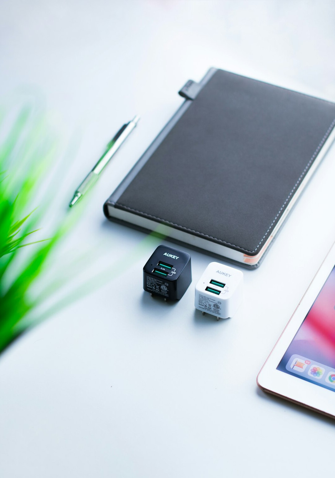 Open notebook, tablet with a course dashboard and coffee on a bright desk