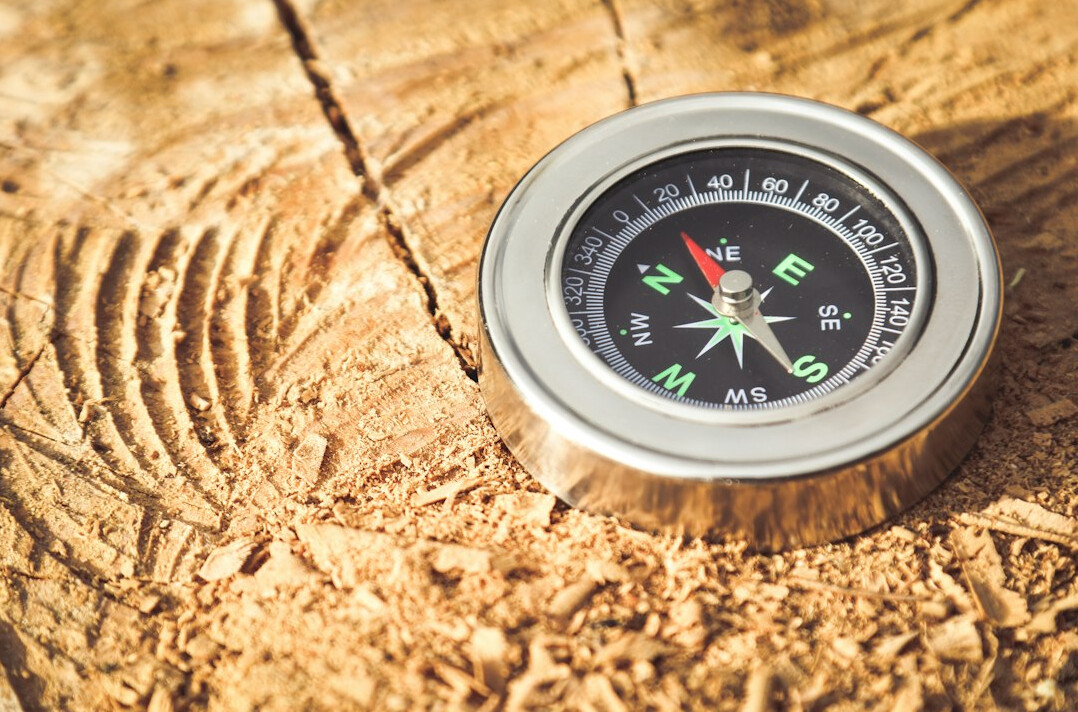 Compass resting on an old map symbolizing direction and change