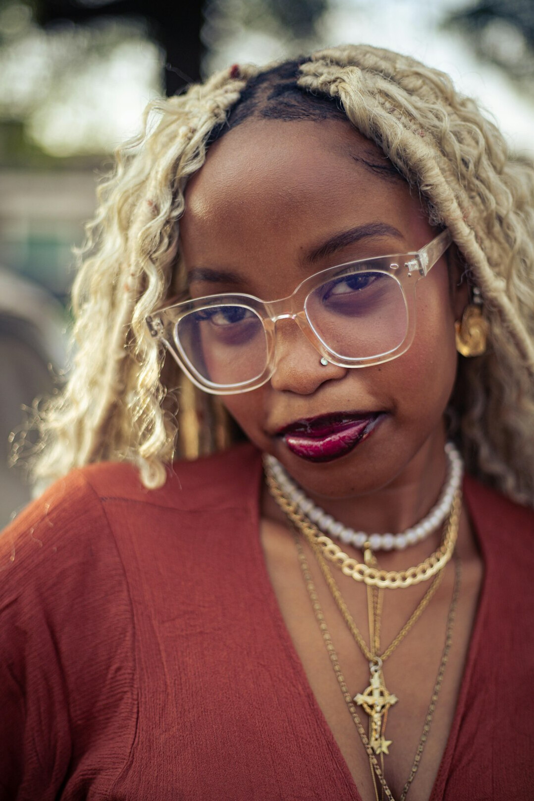 Portrait of a woman with glasses and blonde hair smiling at the camera