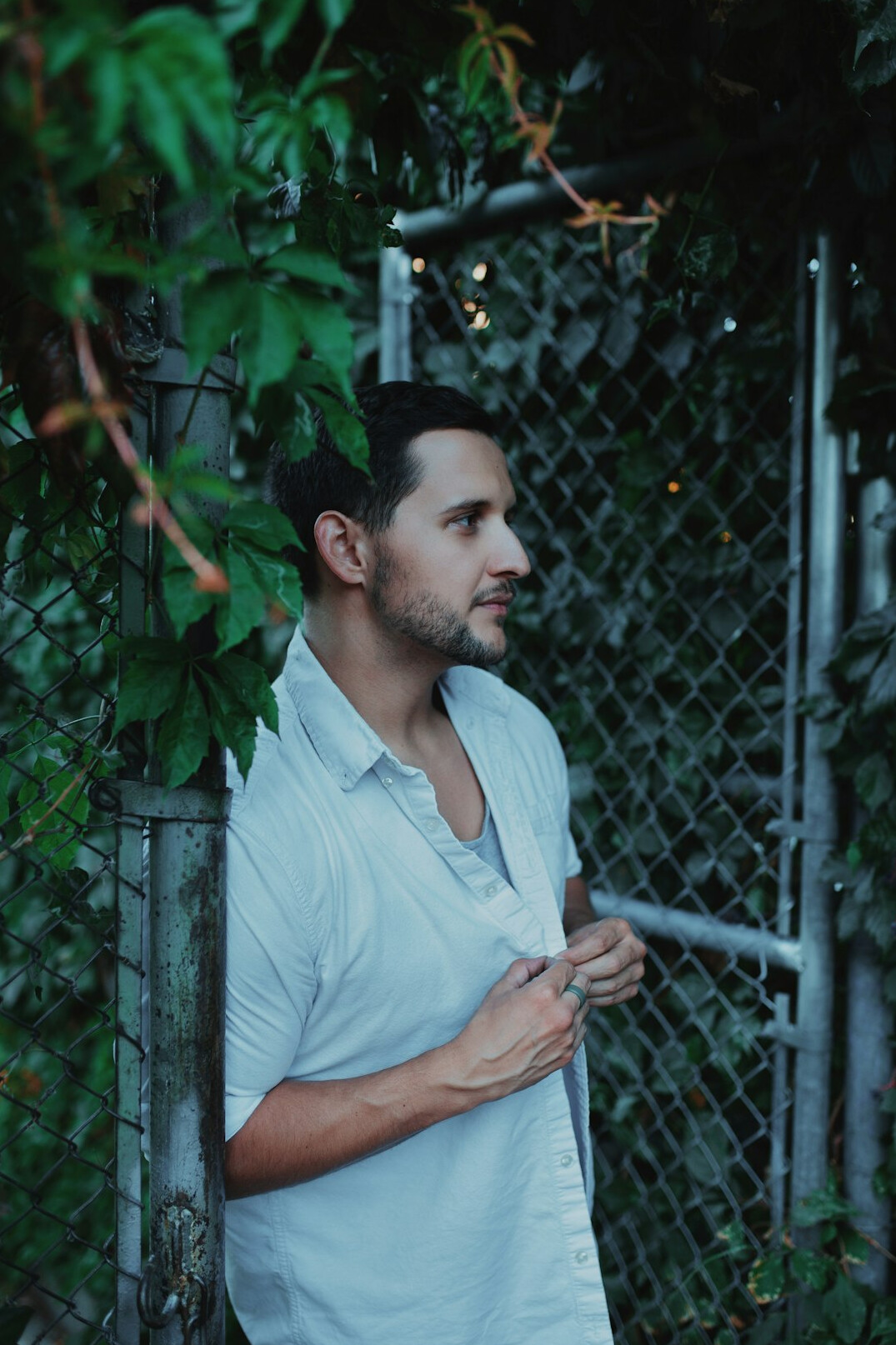 Portrait of a confident man with short dark hair and a light shirt