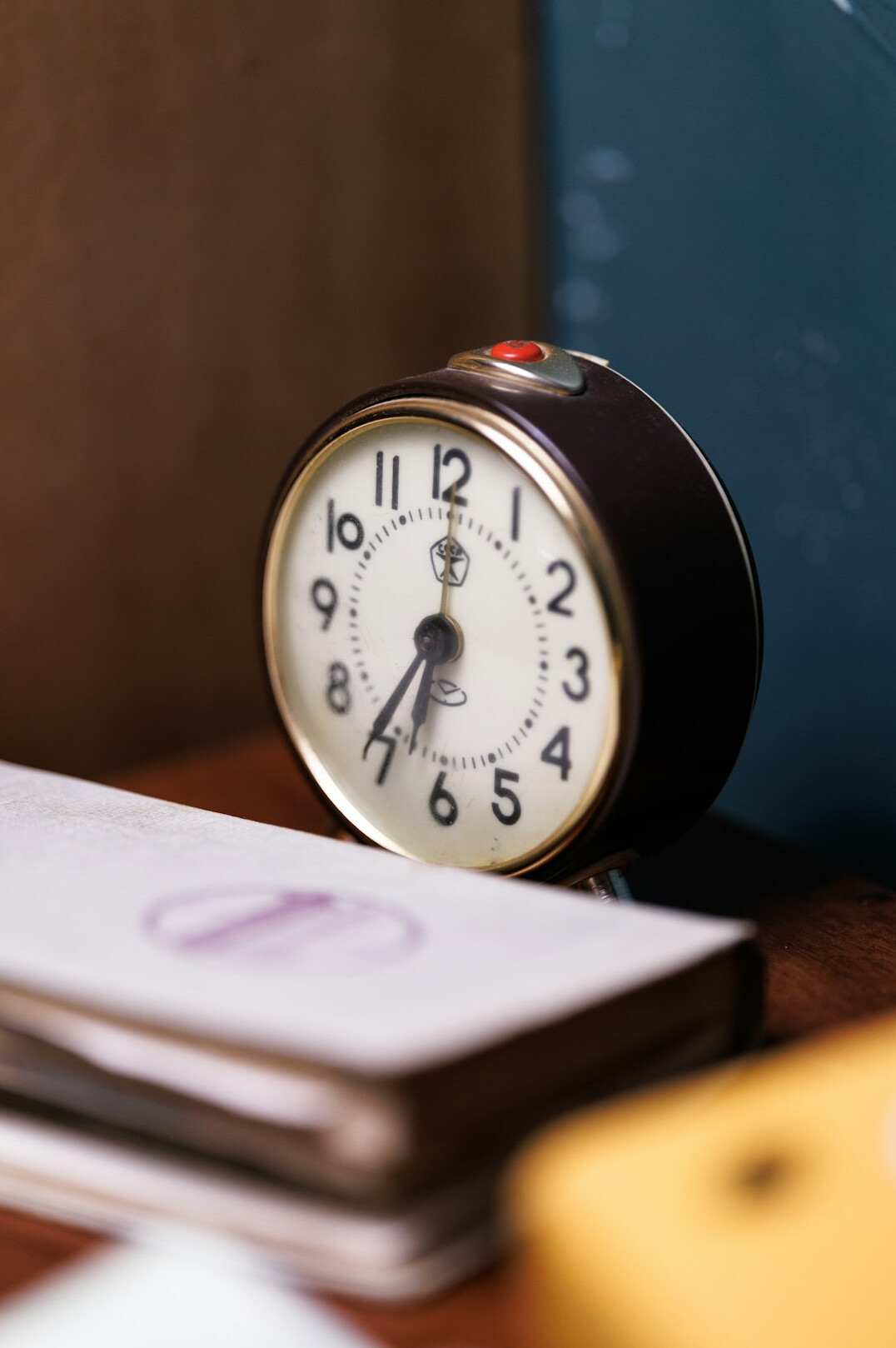 Desk clock and open weekly planner on a tidy desk