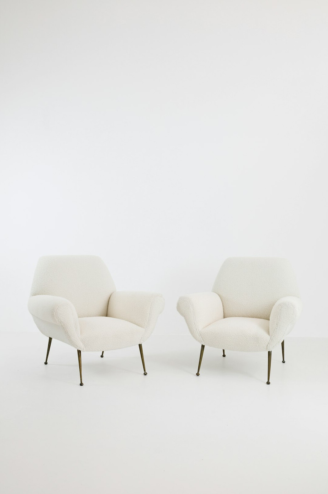 Two armchairs facing each other in a bright meeting room